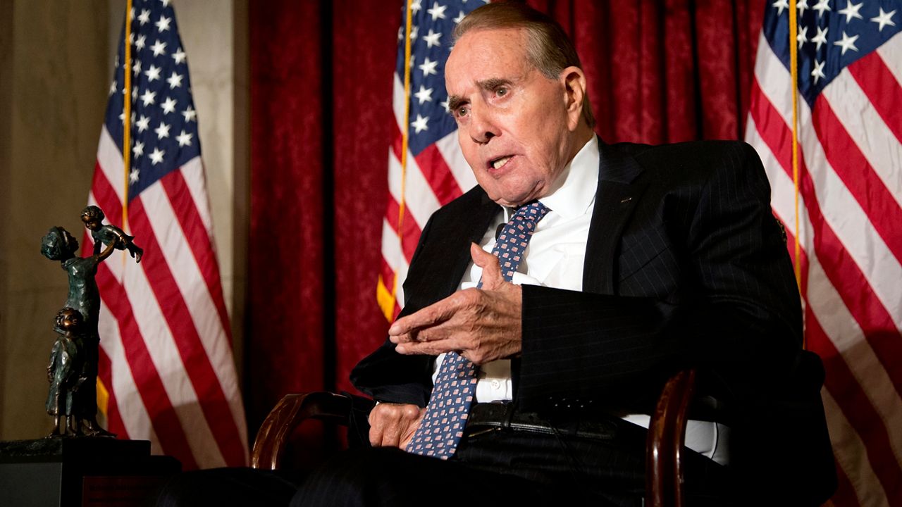 FILE - Former Senate Majority Leader Bob Dole, right, speaks after being presented with the McGovern-Dole Leadership Award by then-Vice President Joe Biden, to honor his leadership in the fight against hunger, during the 12th Annual George McGovern Leadership Award Ceremony hosted by World Food Program USA, on Capitol Hill in Washington, Wednesday, Dec. 11, 2013. (AP Photo/Manuel Balce Ceneta, File)