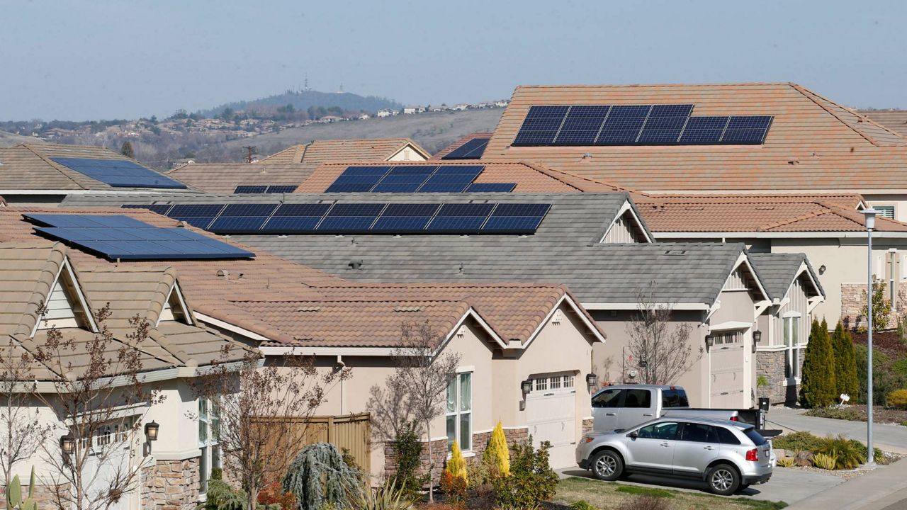 This photo taken Feb. 12, 2020, shows solar panels on rooftops of a housing development in Folsom, Calif. (AP Photo/Rich Pedroncelli, File)