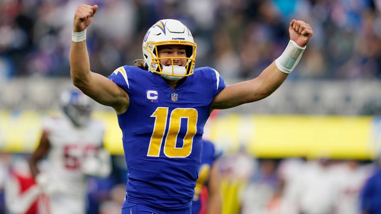 Los Angeles Chargers quarterback Justin Herbert celebrates after throwing a pass to wide receiver Jalen Guyton during the first half of an NFL football game Sunday, Dec. 12, 2021, in Inglewood, Calif. (AP Photo/Gregory Bull)