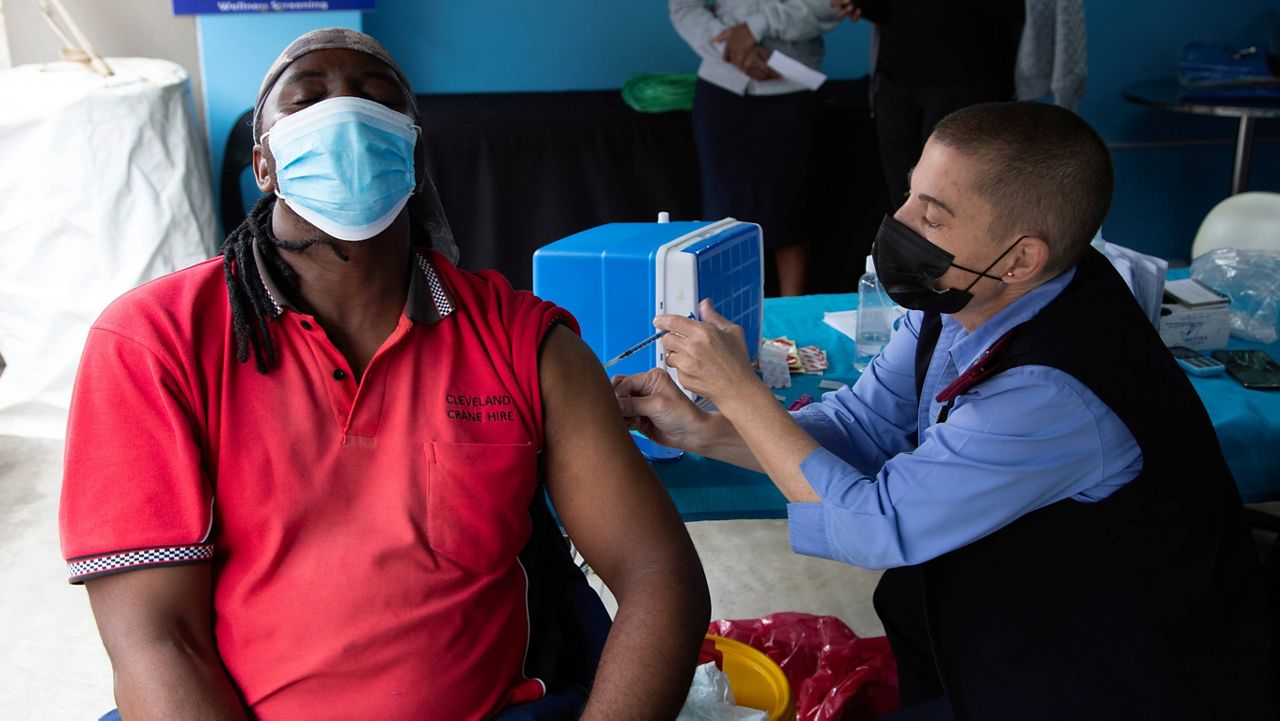 A man gets vaccinated against COVID-19 at a site near Johannesburg on Monday. (AP Photo/Denis Farrell)