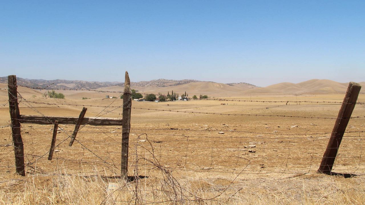 A barbed wire fence runs along a ranch in Sites, Calif., on July 23, 2021. (AP Photo/Adam Beam, File)