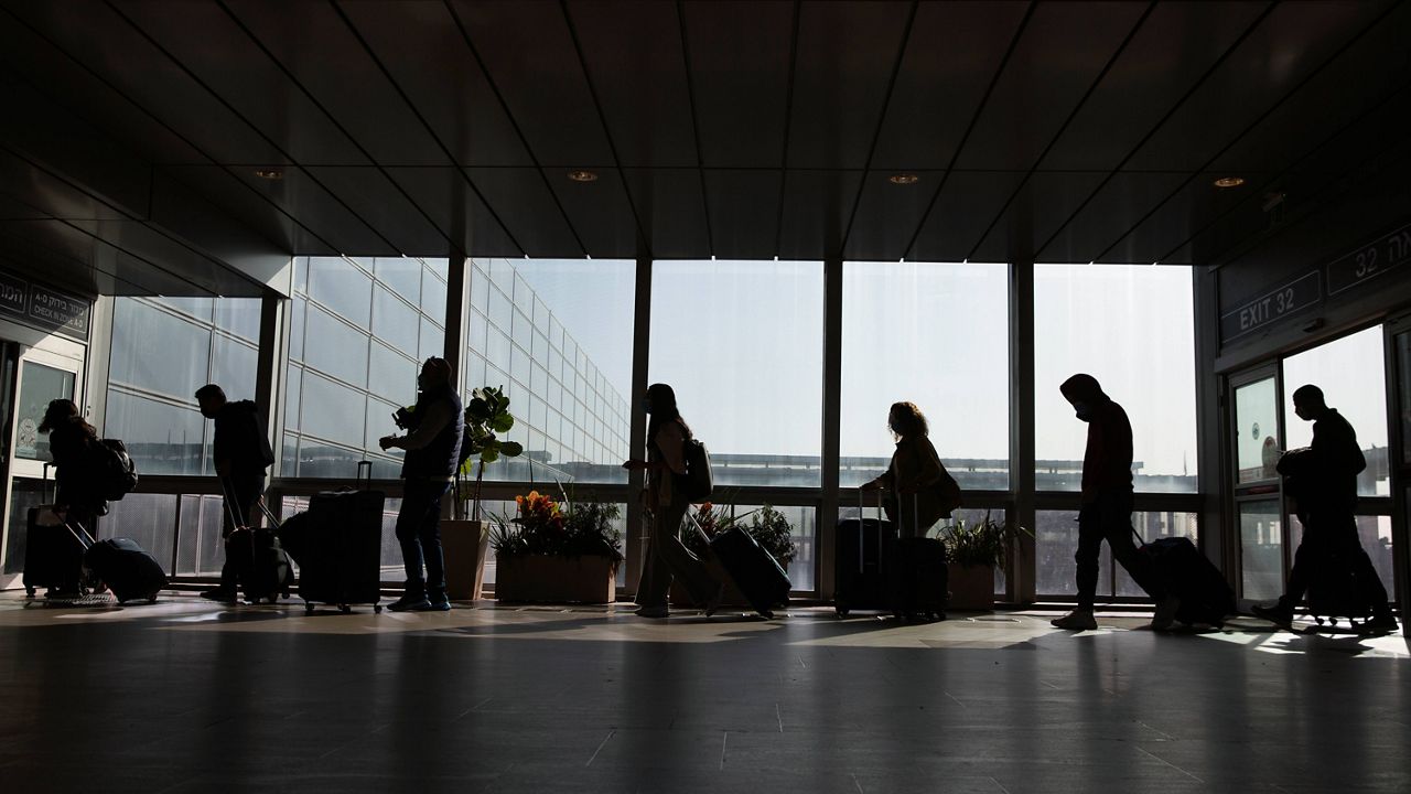 Travelers walk with their luggage in the Ben Gurion Airport near Tel Aviv, Israel, on Nov. 28. (AP Photo/Ariel Schalit, File)