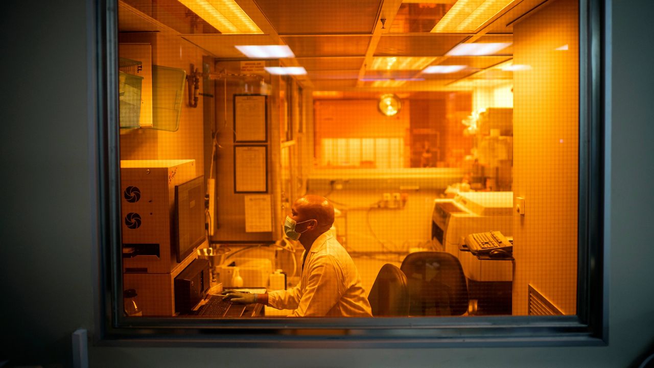 Sandile Cele, a researcher at the Africa Health Research Institute in Durban, South Africa, works on the omicron variant of the COVID-19 virus Wednesday. (AP Photo/Jerome Delay, File)