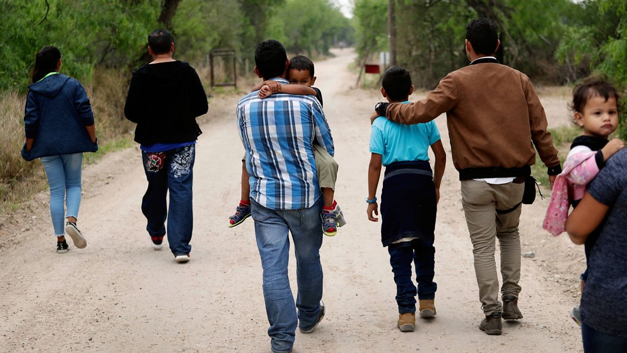 FILE -- A group of migrant families walk from the Rio Grande, the river separating the U.S. and Mexico in Texas, near McAllen, Texas, on March 14, 2019. (AP Photo/Eric Gay, File)