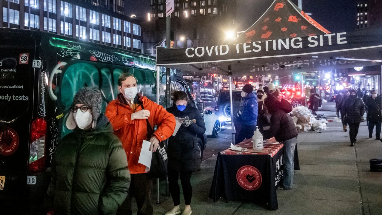 FILE - People wait on line to get tested for COVID-19 on Dec. 21, 2021, in New York. (AP Photo/Brittainy Newman, File)