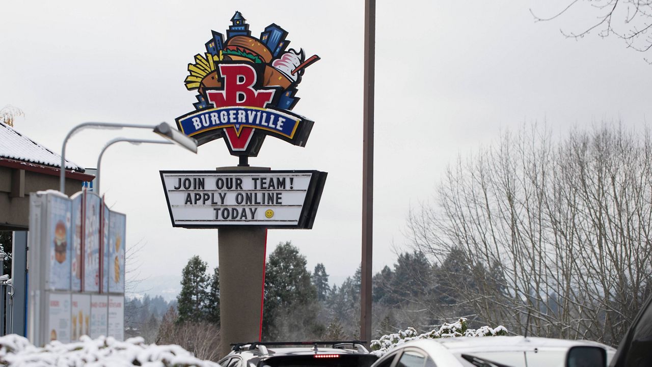 A sign seeking workers is displayed at a fast-food restaurant in Portland, Ore., on Monday. (AP Photo/Jenny Kane)