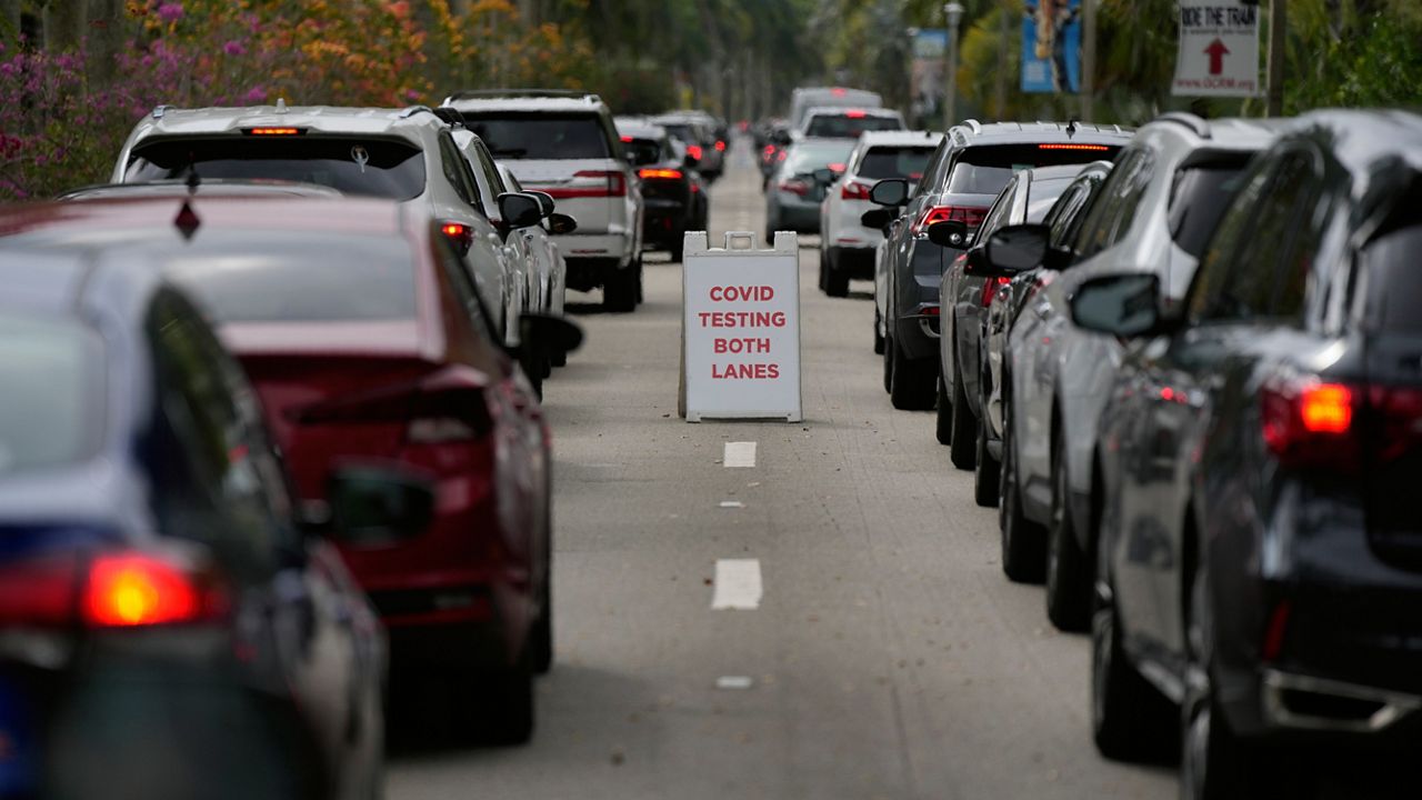 People wait in line in their cars to be tested for COVID-19 at a drive-through testing site at Zoo Miami, Monday, Jan. 3, 2022, in Miami. (AP Photo/Rebecca Blackwell)