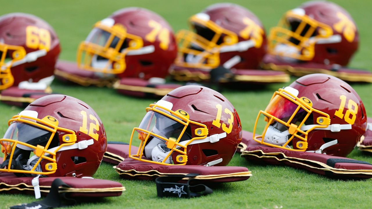 Helmets are lined up before practice during the Washington Football Team's training camp in Richmond, Va., on July 31, 2021. (AP Photo/Dean Hoffmeyer, File)