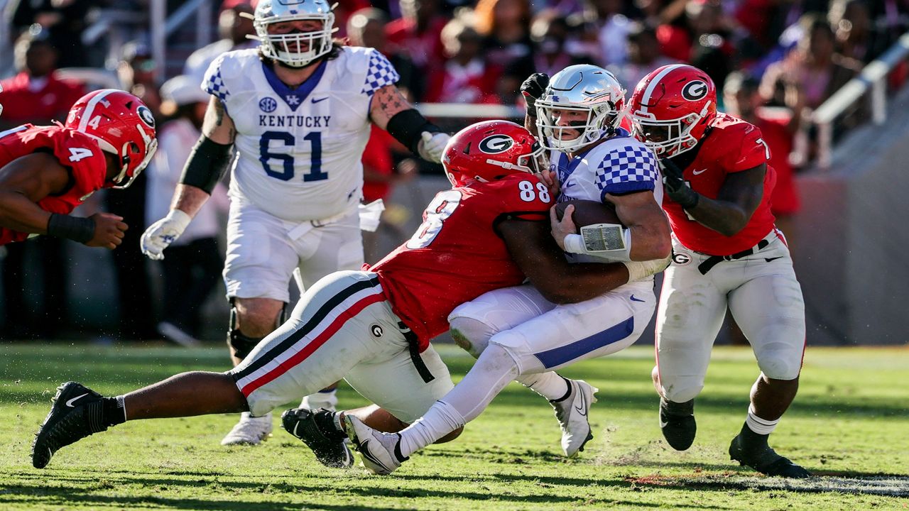 Kentucky quarterback Will Levis (7) is sacked by Georgia defensive lineman Jalen Carter (88) and linebacker Quay Walker (7) during the first half of an NCAA college football game Saturday, Oct. 16, 2021 in Athens, Ga. (AP Photo/Butch Dill, File)