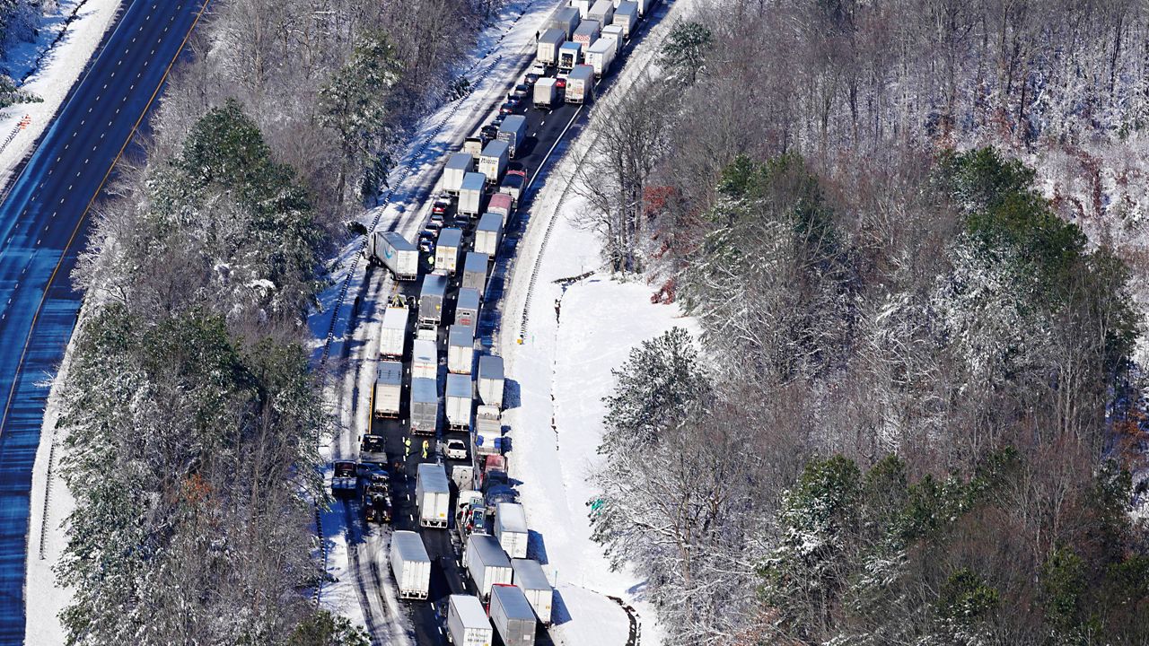Drivers wait for the traffic to be cleared as cars and trucks are stranded on sections of Interstate 95 on Tuesday in Carmel Church, Va. (AP Photo/Steve Helber)