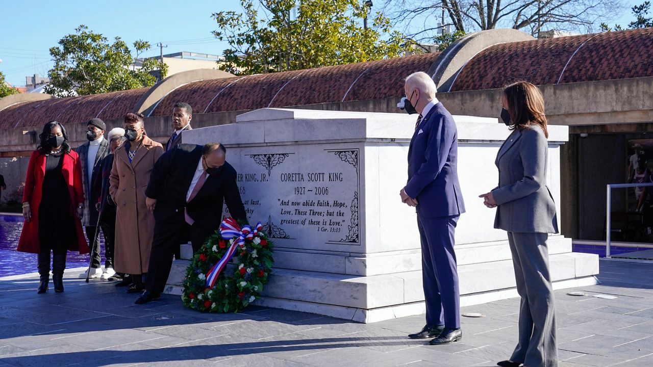 President Joe Biden and Vice President Kamala Harris watch as Martin Luther King III lays a wreath at the tomb of the Rev. Martin Luther King Jr., and his wife Coretta Scott King, Tuesday, Jan. 11, 2022, in Atlanta. (AP Photo/Patrick Semansky)