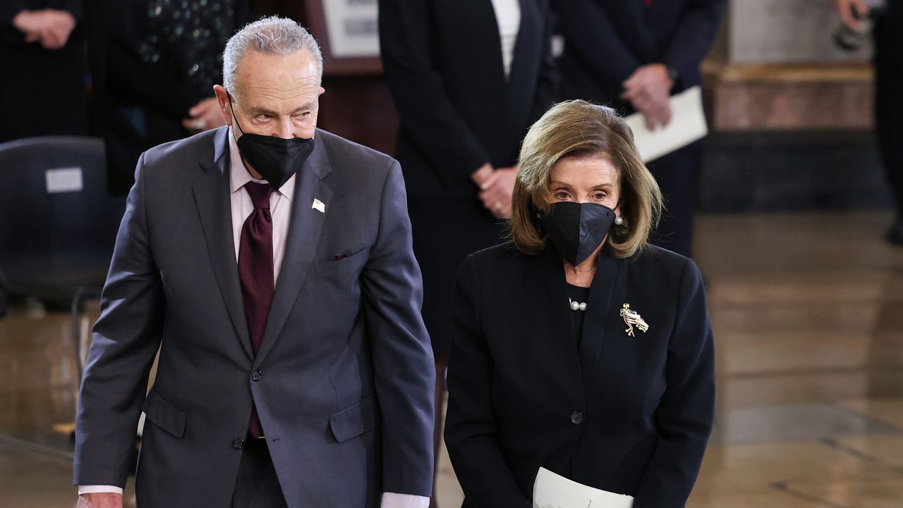 House Speaker Nancy Pelosi of Calif., and Senate Majority Leader Chuck Schumer of N.Y., walk together during a memorial service for former Senate Majority Leader Harry Reid, D-Nev., in the Rotunda of the U.S. Capitol as Reid lies in state, Wednesday, Jan. 12, 2022, in Washington. (Evelyn Hockstein/Pool via AP)