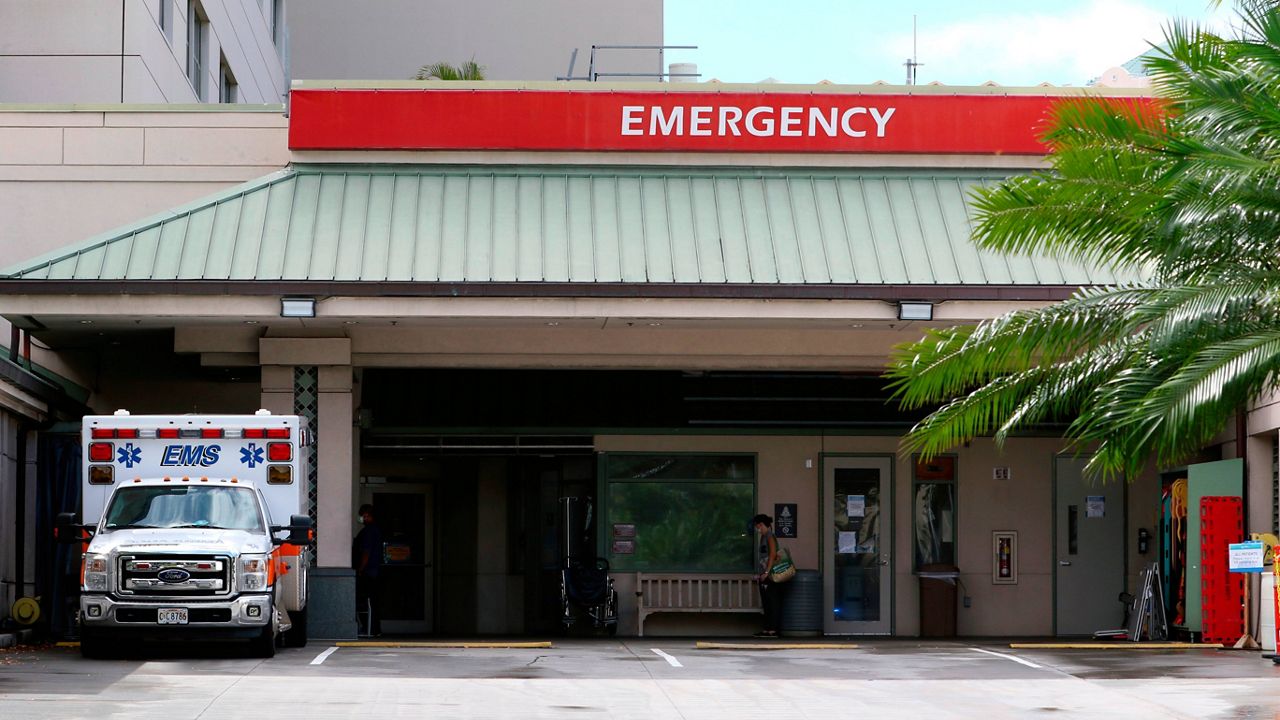 An ambulance sits outside the emergency room at The Queen's Medical Center in Honolulu. (AP Photo/Caleb Jones, File)