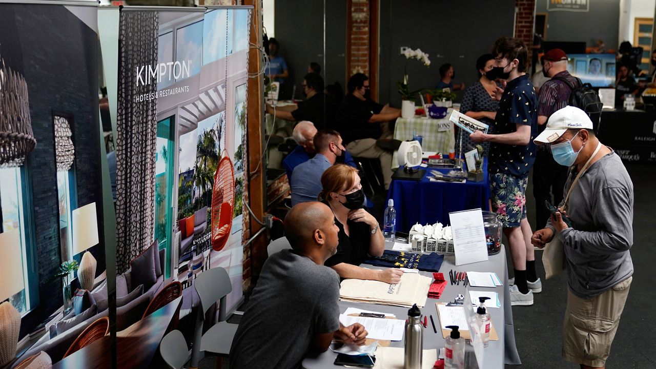 FILE - Prospective employers and job seekers interact during a job fair Sept. 22, 2021, in the West Hollywood section of Los Angeles. (AP Photo/Marcio Jose Sanchez, File)