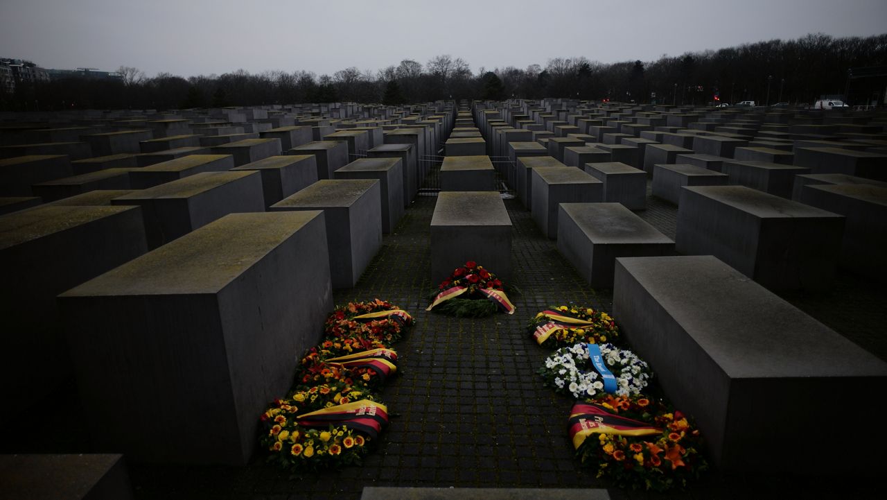 Wreaths placed at the Memorial to the Murdered Jews of Europe on the International Holocaust Remembrance Day in Berlin, Germany, Thursday, Jan. 27, 2022. (AP Photo/Markus Schreiber)