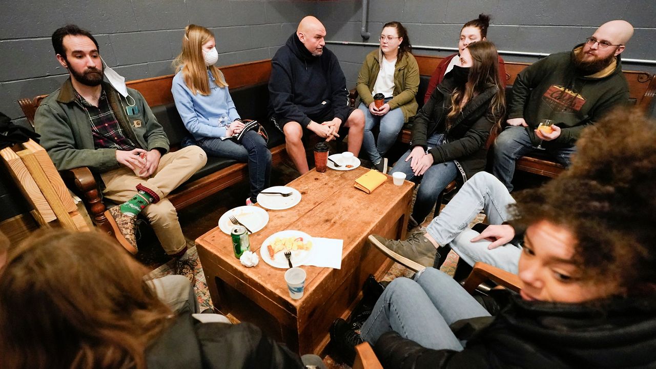 Democratic candidate for the Pennsylvania U.S.senate seat in the 2022 primary election, Lt. Gov. John Fetterman, center, greets people as arrives for a campaign stop at the Mechanistic Brewery, in Clarion, Pa., Saturday, Feb. 12, 2022. (AP Photo/Keith Srakocic)