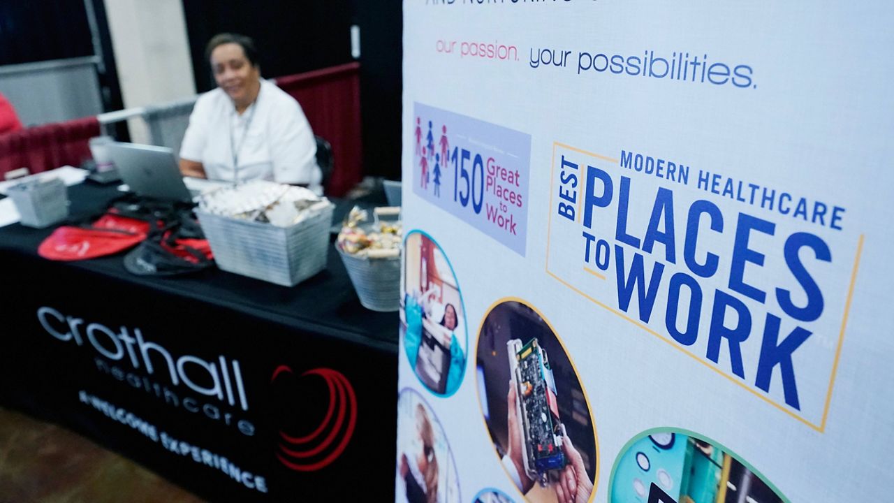 A representative mans a company's booth during the Lee County Area Job Fair in Tupelo, Miss., Tuesday, Oct. 12, 2021. (AP Photo/Rogelio V. Solis, File)