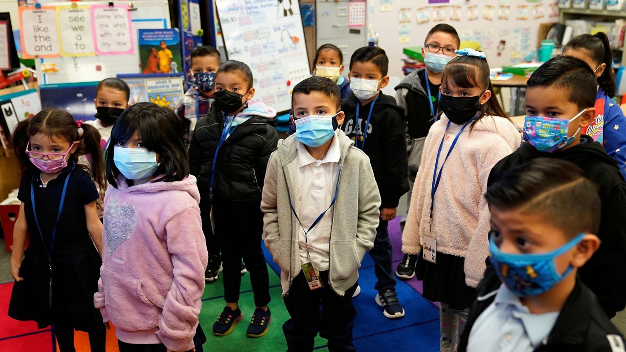 FILE - Kindergarteners wear masks while listening to their teacher amid the COVID-19 pandemic at Washington Elementary School on Jan. 12, 2022, in Lynwood, Calif. (AP Photo/Marcio Jose Sanchez, File)