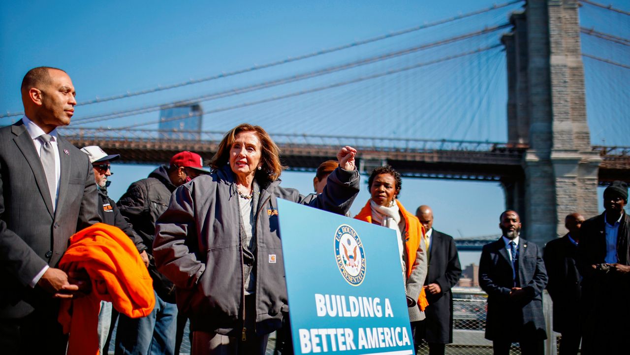 Speaker of the House Nancy Pelosi, D-Calif., speaks during a news conference on infrastructure, next to Democratic Caucus Chair Hakeem Jeffries, D-N.Y., left and Rep. Yvette Clarke, D-N.Y., at Pier One at Brooklyn Bridge Park, Monday, March 14, 2022, in New York. (AP Photo/Eduardo Munoz Alvarez)