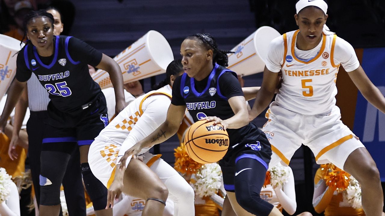 Buffalo guard Dyaisha Fair (2) drives past Tennessee guard Jordan Walker (4) during the first half of a college basketball game in the first round of the NCAA tournament, Saturday, March 19, 2022, in Knoxville, Tenn. (AP Photo/Wade Payne)