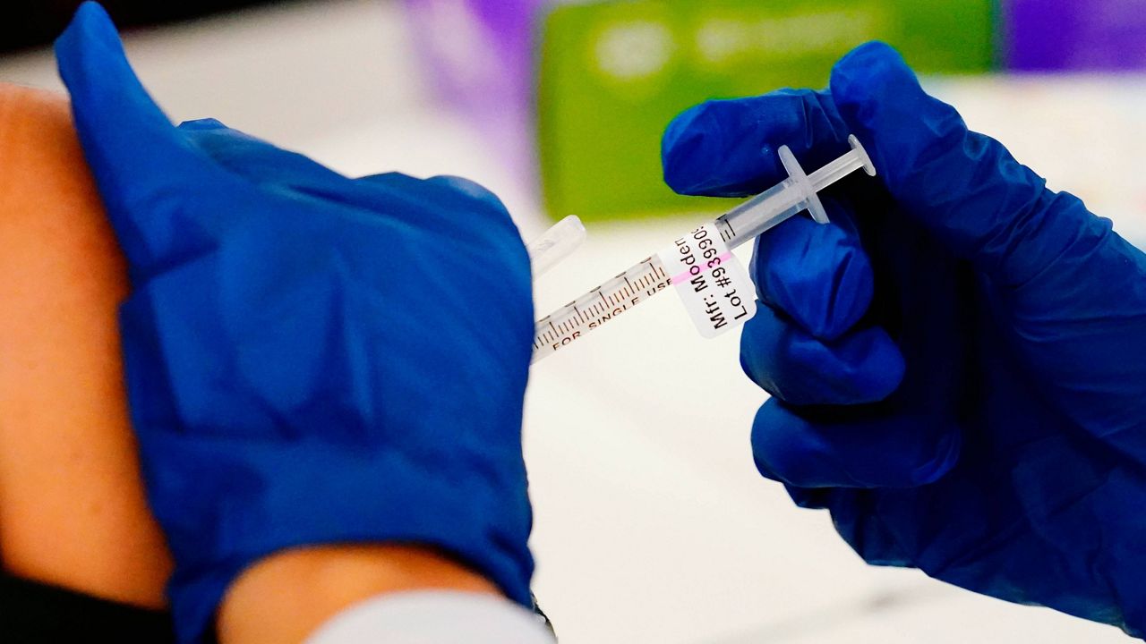 A health worker administers a dose of a Moderna COVID-19 vaccine during a vaccination clinic at the Norristown Public Health Center in Norristown, Pa., on Dec. 7, 2021. (AP Photo/Matt Rourke, File)