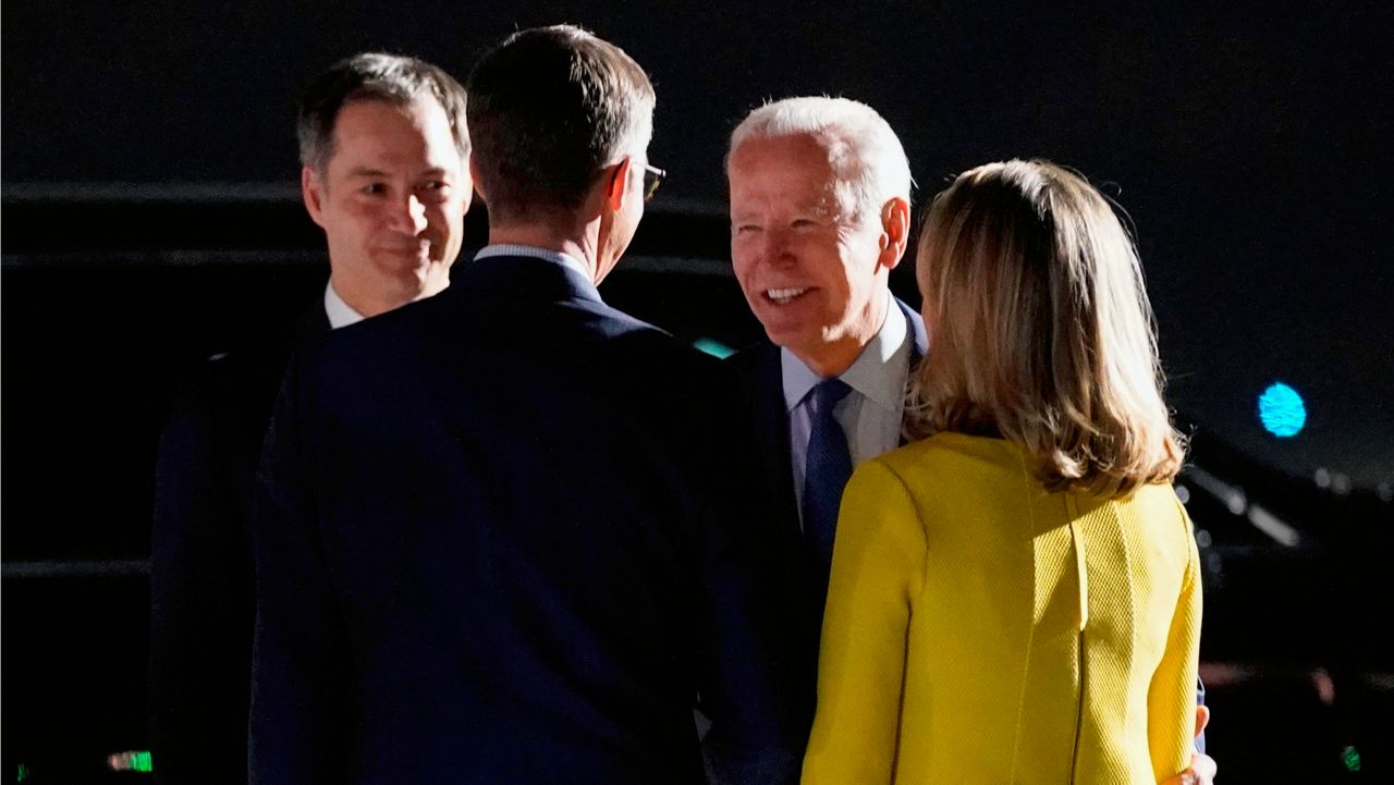 President Joe Biden and Belgian Prime Minister Alexander de Croo, left, talk to people after arriving at Brussels National Airport, Wednesday, March 23, 2022, in Brussels. (AP Photo/Evan Vucci)