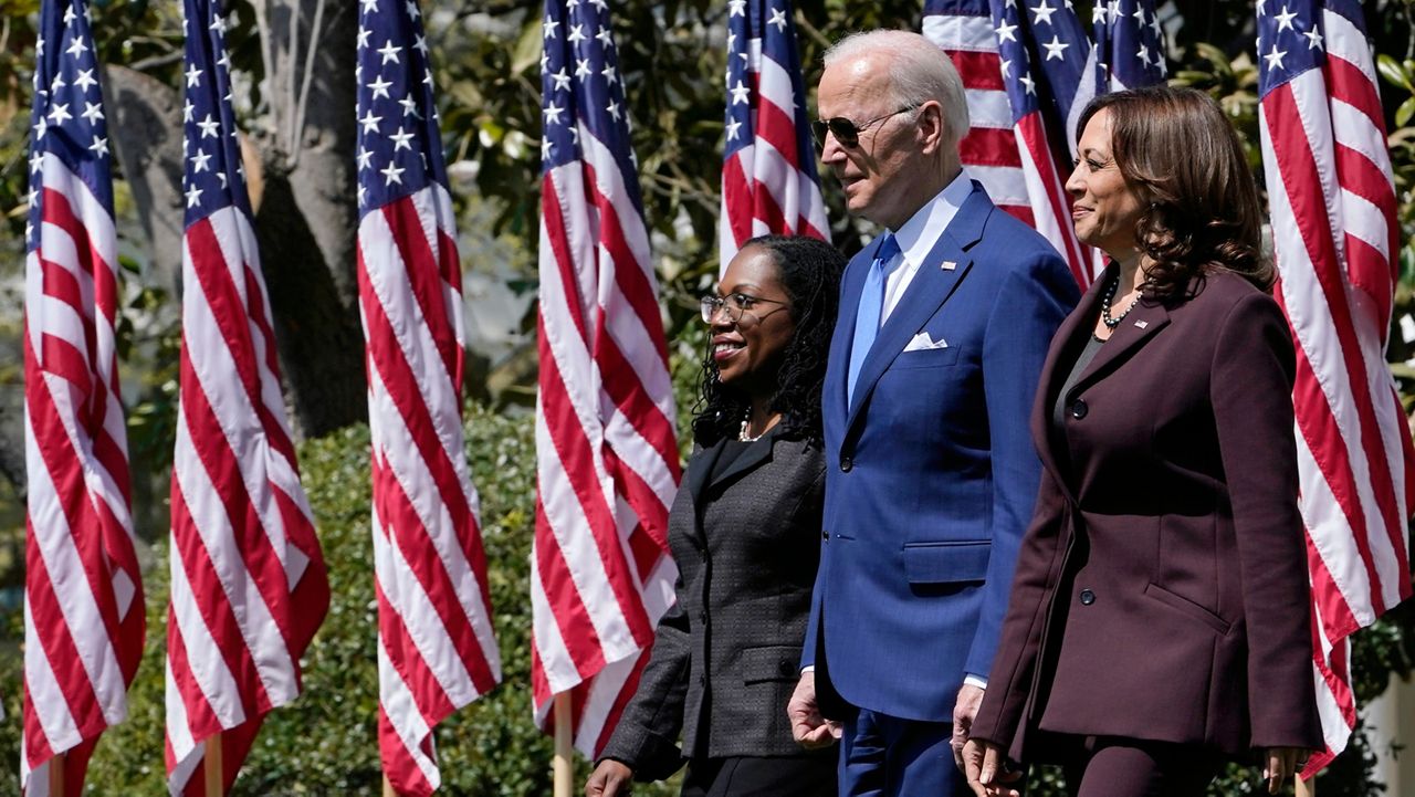 Judge Ketanji Brown Jackson, left, walks with President Joe Biden, center, and Vice President Kamala Harris, right, as they arrive for an event on the South Lawn of the White House in Washington, Friday, April 8, 2022, celebrating the confirmation of Jackson as the first Black woman to reach the Supreme Court. (AP Photo/Susan Walsh)