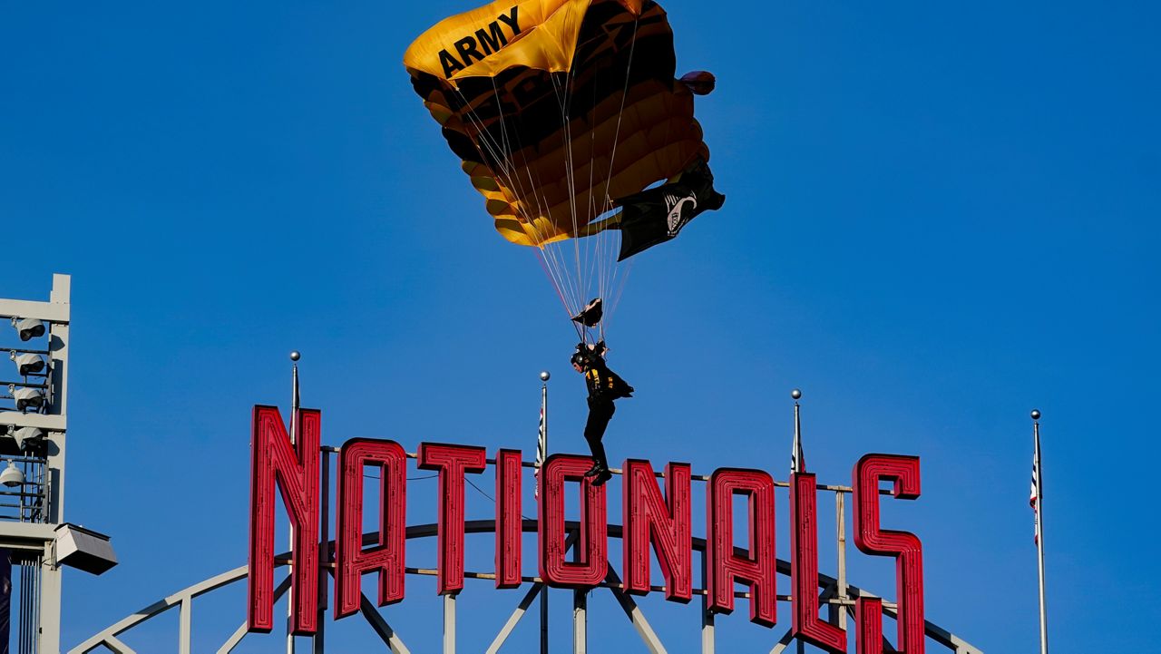 The U.S. Army Parachute Team the Golden Knights descend into National Park before a baseball game between the Washington Nationals and the Arizona Diamondbacks Wednesday, April 20, 2022, in Washington. (AP Photo/Alex Brandon)