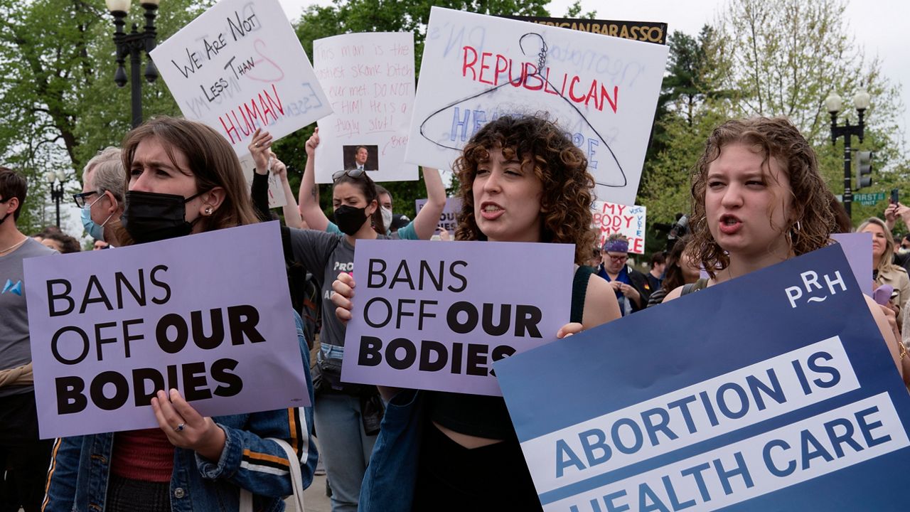 Demonstrators protest outside of the U.S. Supreme Court Tuesday, May 3, 2022 in Washington. (AP Photo/Jose Luis Magana)