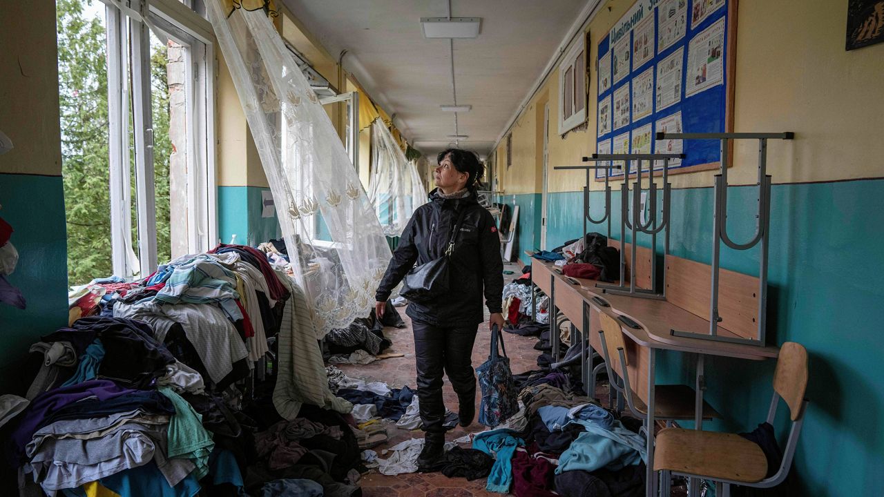 School official Iryna Homenko walks on April 13 in the hall of a school damaged by an airstrike from Russian forces in Chernihiv, Ukraine. (AP Photo/Evgeniy Maloletka, File)