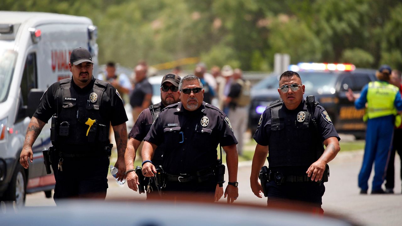 Police walk near Robb Elementary School following a shooting, Tuesday, May 24, 2022, in Uvalde, Texas. (AP Photo/Dario Lopez-Mills)