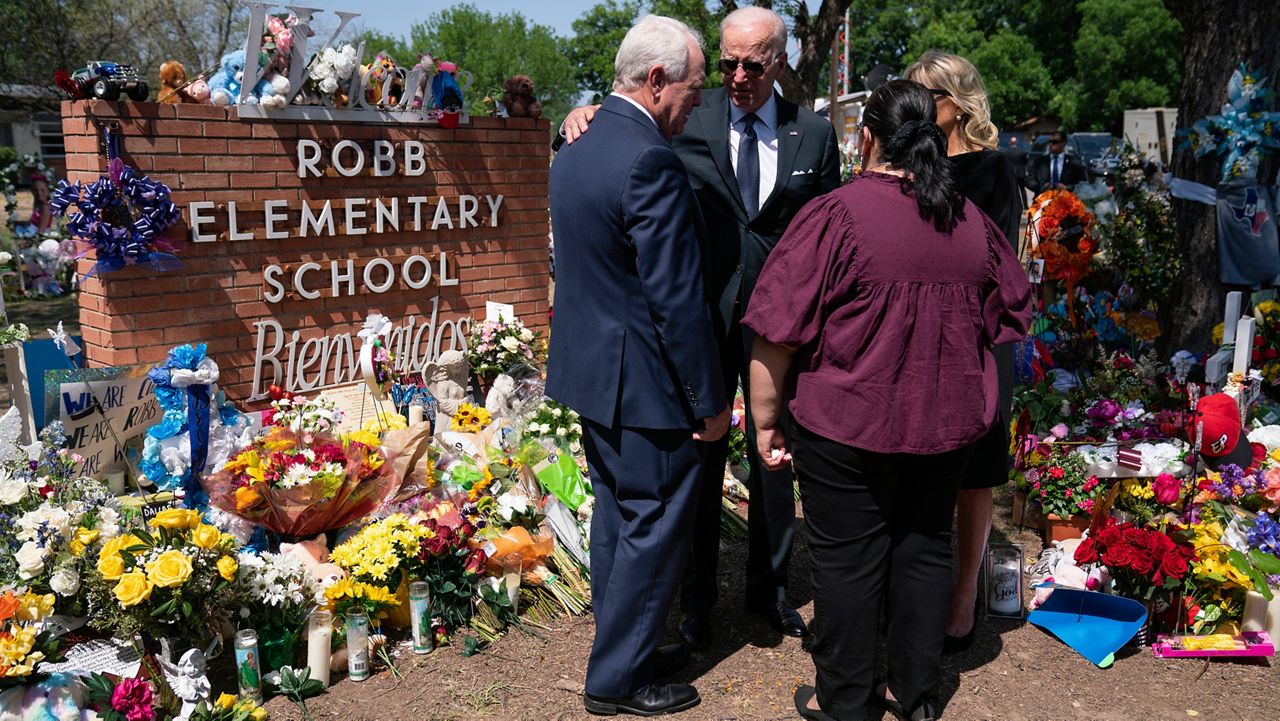 President Joe Biden and first lady Jill Biden talk with principal Mandy Gutierrez and superintendent Hal Harrell as they visit Robb Elementary School to pay their respects to the victims of the mass shooting, Sunday, May 29, 2022, in Uvalde, Texas. (AP Photo/Evan Vucci)