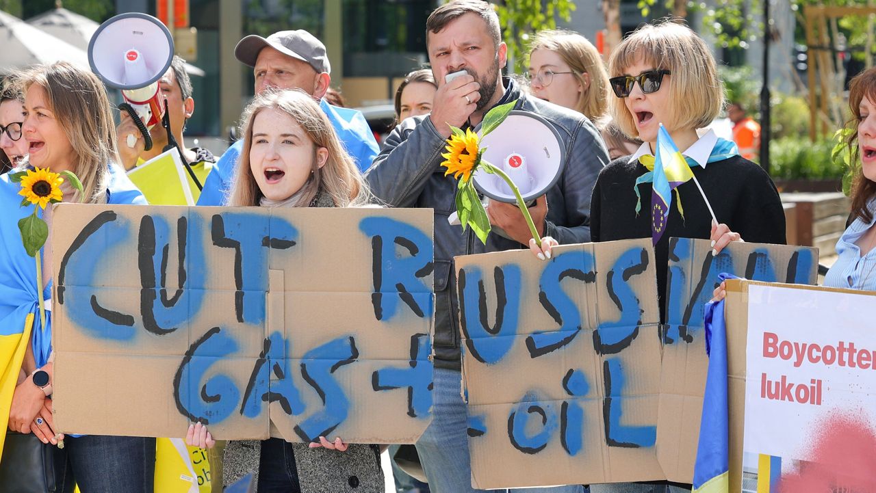 Ukrainian demonstrators demand an embargo on Russian oil during a protest in front of EU institutions prior to an extraordinary meeting of EU leaders to discuss Ukraine, energy and food security at the Europa building in Brussels, Monday, May 30, 2022. (AP Photo/Olivier Matthys)