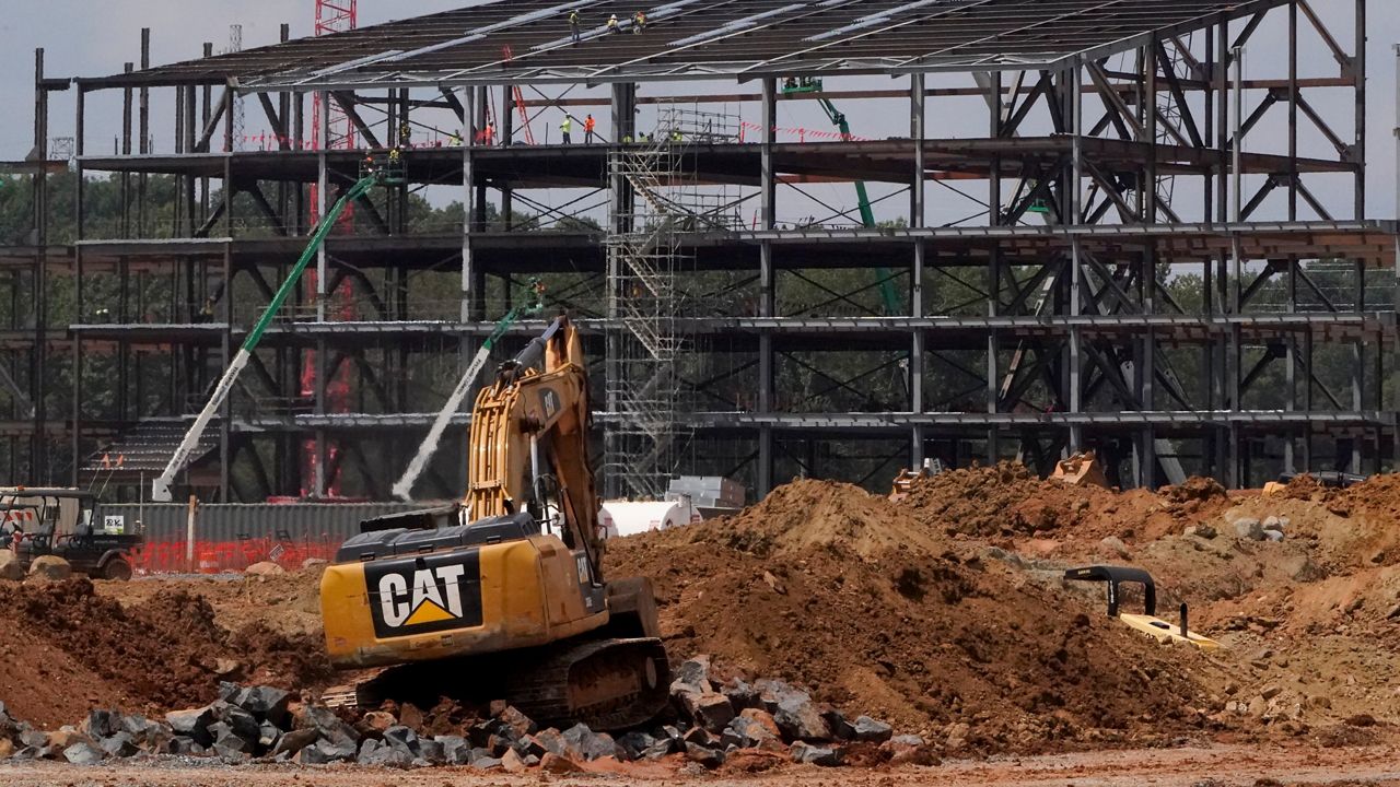 Construction personnel work on the Carolina Panthers' team headquarters and practice facility Aug. 24, 2021, in Rock Hill, S.C. The Panthers' proposed $800 million practice facility project in Rock Hill is officially dead after team owner David Tepper’s real estate company filed for Chapter 11 bankruptcy protection in Delaware on Wednesday night, June 1, 2022. (AP Photo/Chris Carlson, File)