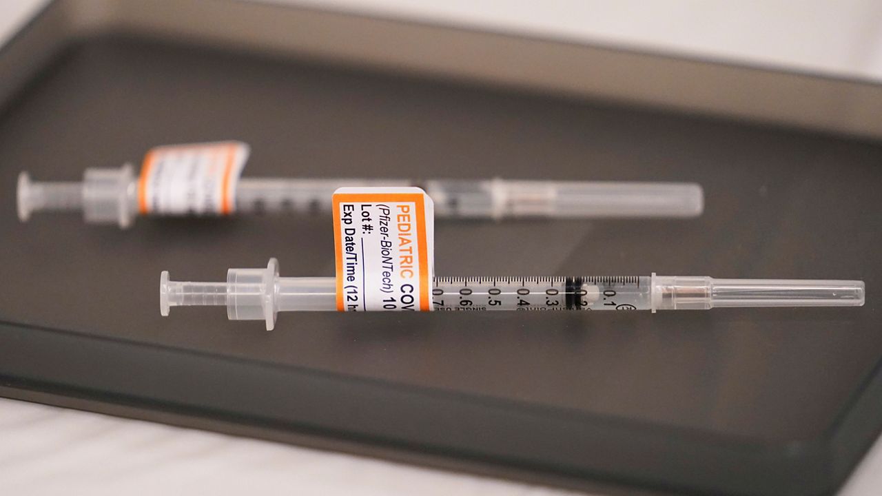 FILE - Prepared Pfizer COVID-19 vaccine syringes for children ages 5 to 11 and adults are displayed on a table at Northwest Community Church in Chicago, Dec. 11, 2021. (AP Photo/Nam Y. Huh, File)