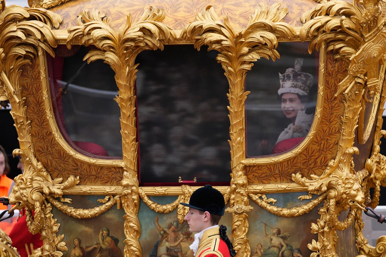 The image of Queen Elizabeth II is seen in a golden carriage during the Platinum Jubilee Pageant outside Buckingham Palace in London, Sunday, June 5, 2022, on the last of four days of celebrations to mark the Platinum Jubilee. The pageant will be a carnival procession up The Mall featuring giant puppets and celebrities that will depict key moments from the Queen Elizabeth II's seven decades on the throne. (AP Photo/Frank Augstein, Pool)