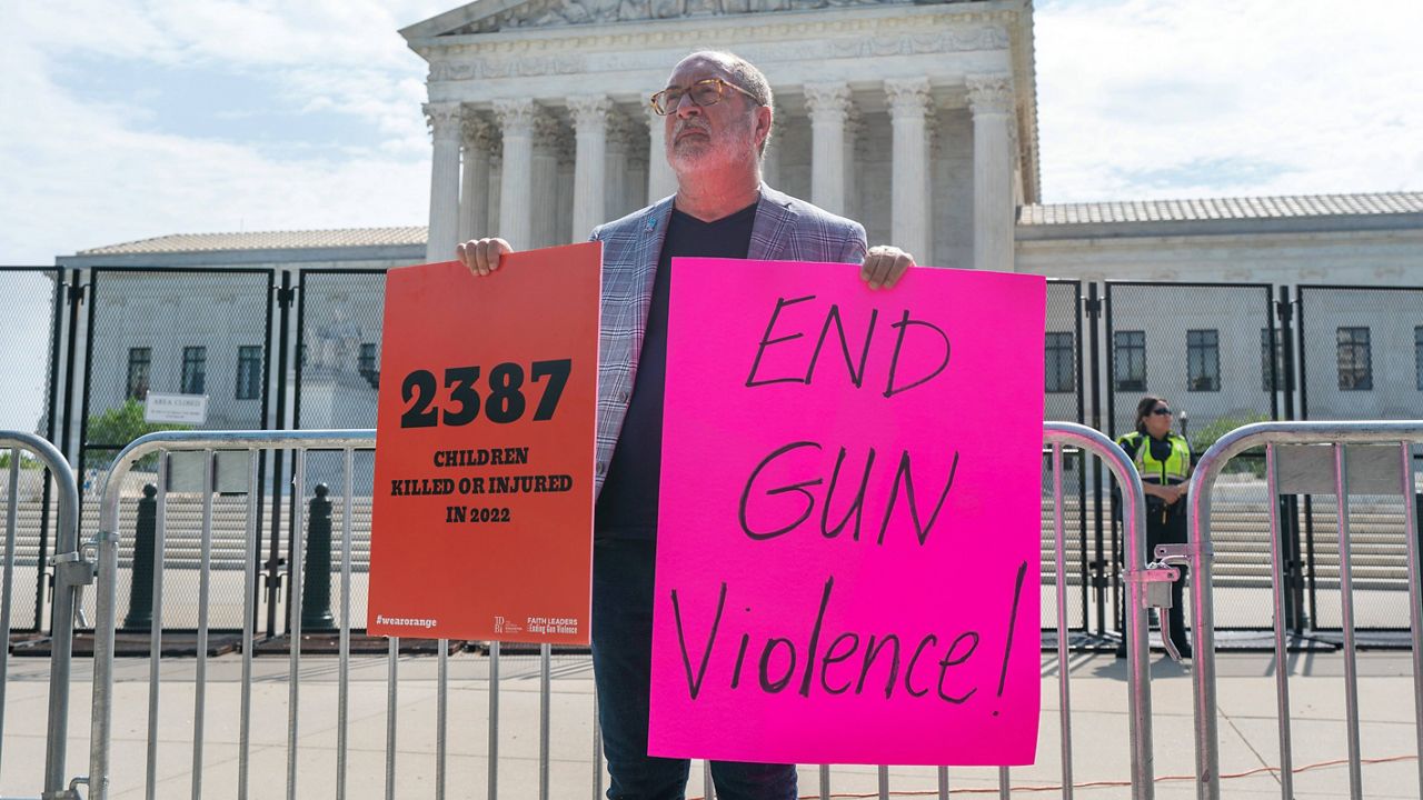 Rev. Patrick Mahoney, with the group Faith Leaders Ending Gun Violence, protests gun violence Wednesday outside the Supreme Court in Washington. (AP Photo/Jacquelyn Martin)