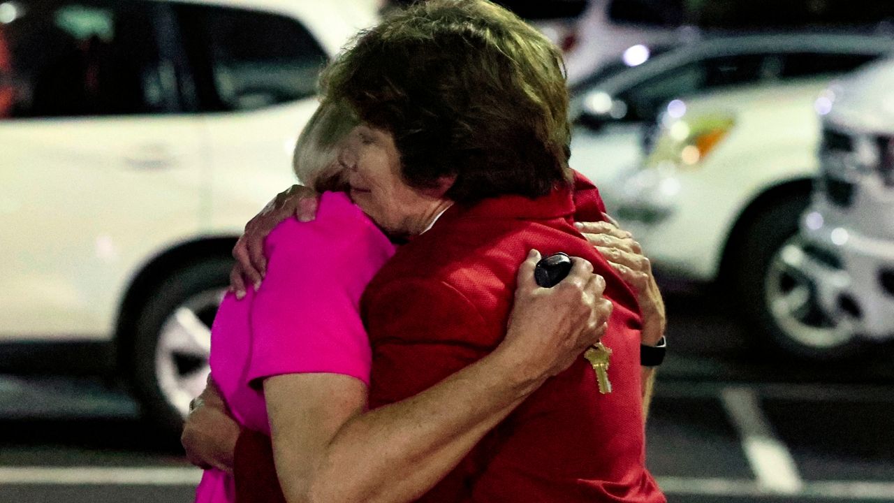 Church members console each other after a shooting at the Saint Stephen’s Episcopal Church on Thursday, June 16, 2022 in Vestavia, Ala. (AP Photo/Butch Dill)