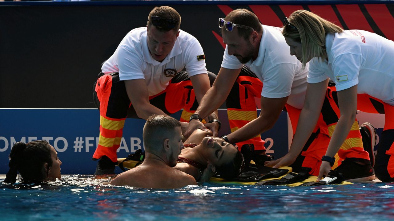 Anita Alvarez of United States is taken from the pool after collapsing during the solo free final of the artistic swimming at the 19th FINA World Championships in Budapest, Hungary, Wednesday, June 22, 2022. (AP Photo/Anna Szilagyi)