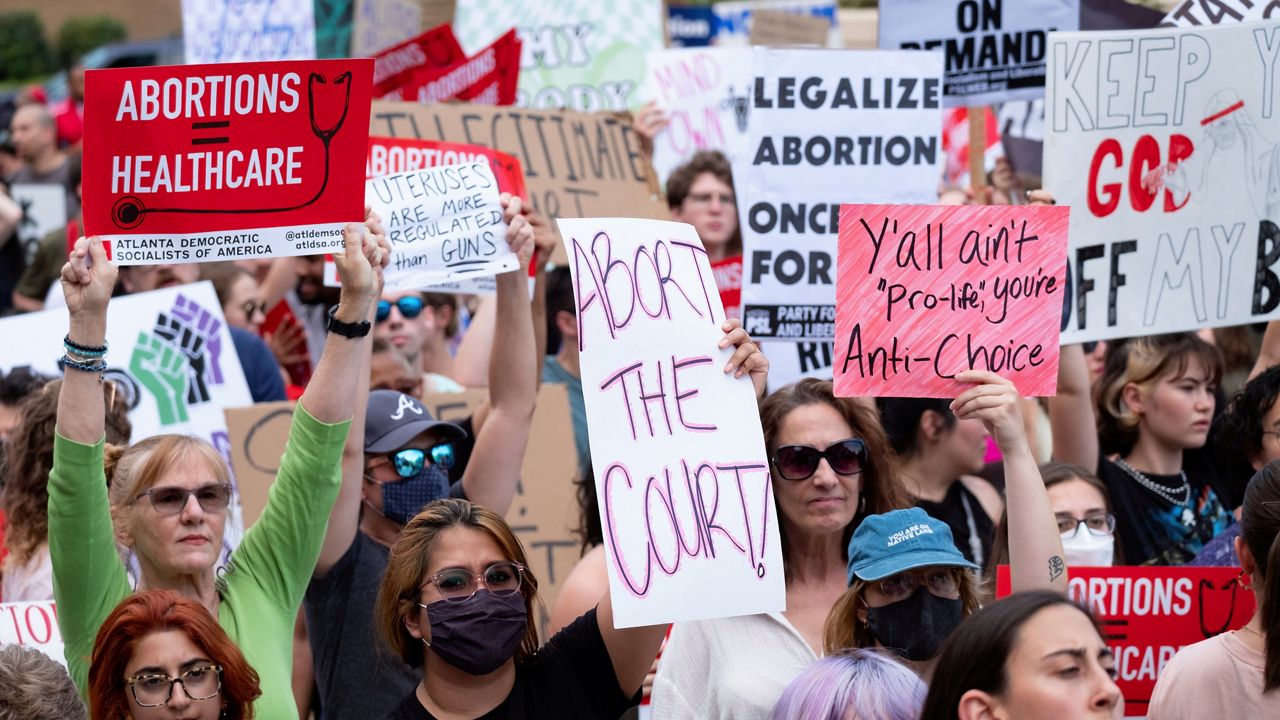 People gather in front of the Georgia State Capital in Atlanta on Friday, June 24, 2022, to protest to protest the Supreme Court's decision to overturn Roe v. Wade. (AP Photo/Ben Gray)