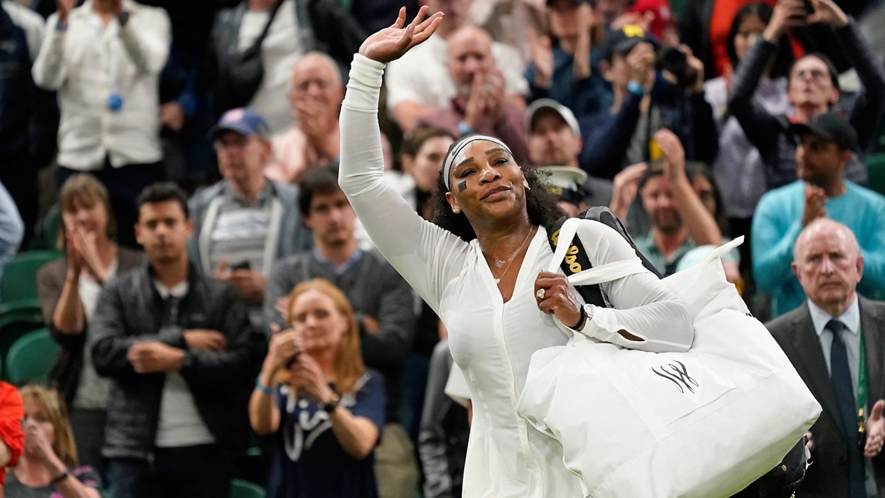 Serena Williams waves as she leaves the court after losing to France's Harmony Tan in a first round women's singles match on day two of the Wimbledon tennis championships in London, Tuesday, June 28, 2022. (AP Photo/Alberto Pezzali)