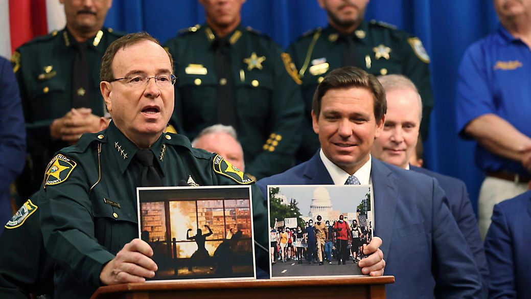 Polk County Sheriff Grady Judd speaks during a press conference with Gov. Ron DeSantis at the Polk County Sheriff's Office in Winter Haven, Fla., on, April 19, 2021. Sheriff Judd, with his folksy Southern drawl, uses social media to target drug dealers, prostitution rings, gangs and human traffickers. (Ricardo Ramirez Buxeda/Orlando Sentinel via AP)