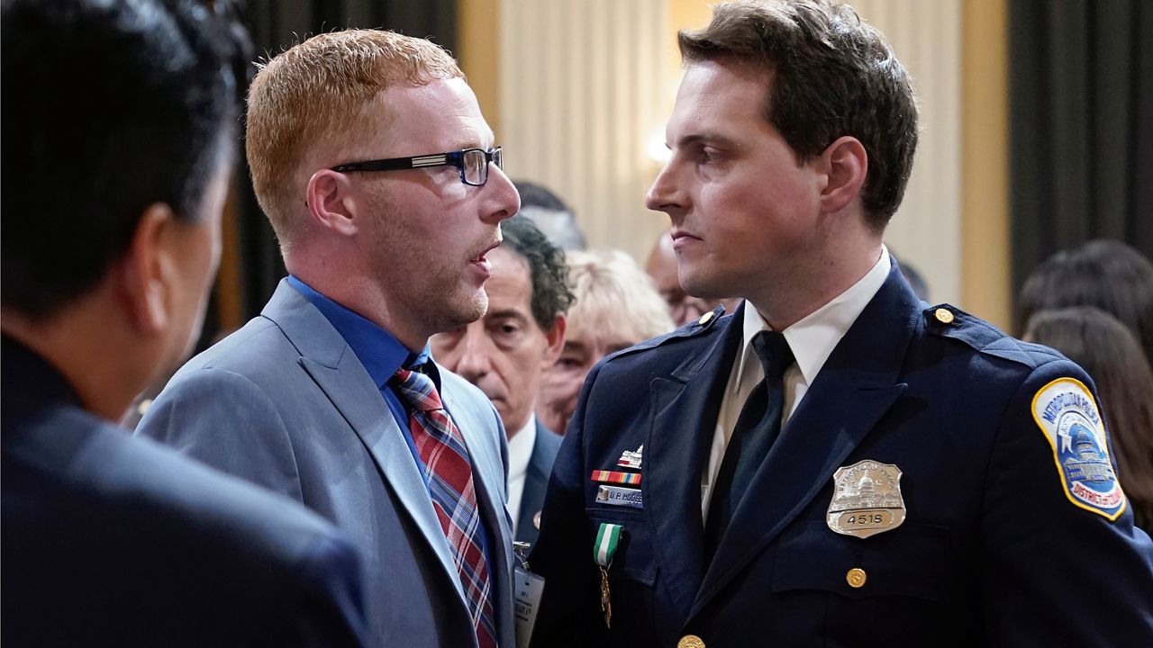 Stephen Ayres, who pleaded guilty last in June 2022 to disorderly and disruptive conduct in a restricted building, shakes hands with Washington Metropolitan Police Department officer Daniel Hodges as the hearing with the House select committee investigating the Jan. 6 attack on the U.S. Capitol, concludes at the Capitol in Washington, Tuesday, July 12, 2022. (AP Photo/Jacquelyn Martin)