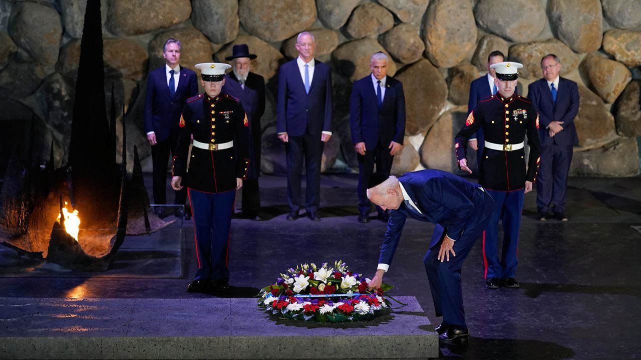President Joe Biden, wearing a yarmulke, participates in a wreath laying ceremony in the Hall of Remembrance at Yad Vashem, Wednesday, July 13, 2022, in Jerusalem. (AP Photo/Evan Vucci)