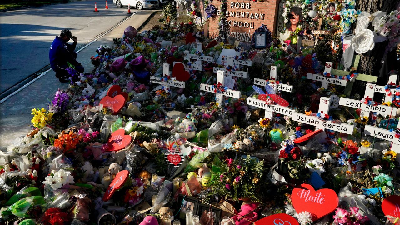 A man pays his respects at a memorial outside Robb Elementary School to honor the victims killed in last week's school shooting, on June 2, 2022, in Uvalde, Texas. (AP Photo/Eric Gay, File)