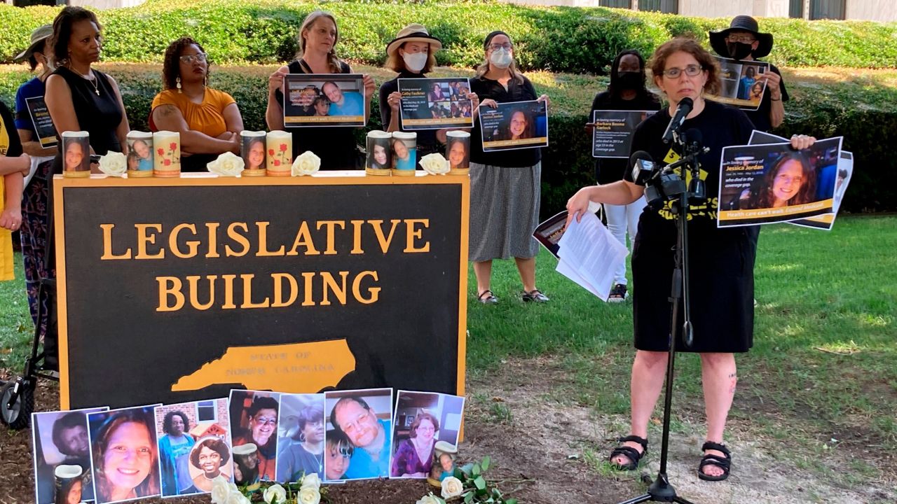 Rebecca Cerese, a policy advocate at the North Carolina Justice Center, speaks at a vigil in front of the North Carolina Legislative Building in Raleigh, N.C., Tuesday, July 26, 2022, to remember people lacking Medicaid coverage or insurance who have died. Cerese and other speakers urged lawmakers to pass a law so North Carolina accepts federal funds to expand Medicaid coverage to hundreds of thousands of additional adults (AP Photo/Gary D. Robertson)