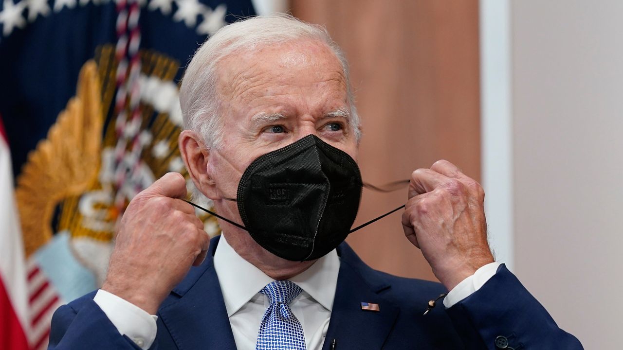 FILE - President Joe Biden removes his face mask as he arrives to speak about the economy during a meeting with CEOs in the South Court Auditorium on the White House complex in Washington, Thursday, July 28, 2022. (AP Photo/Susan Walsh, File)