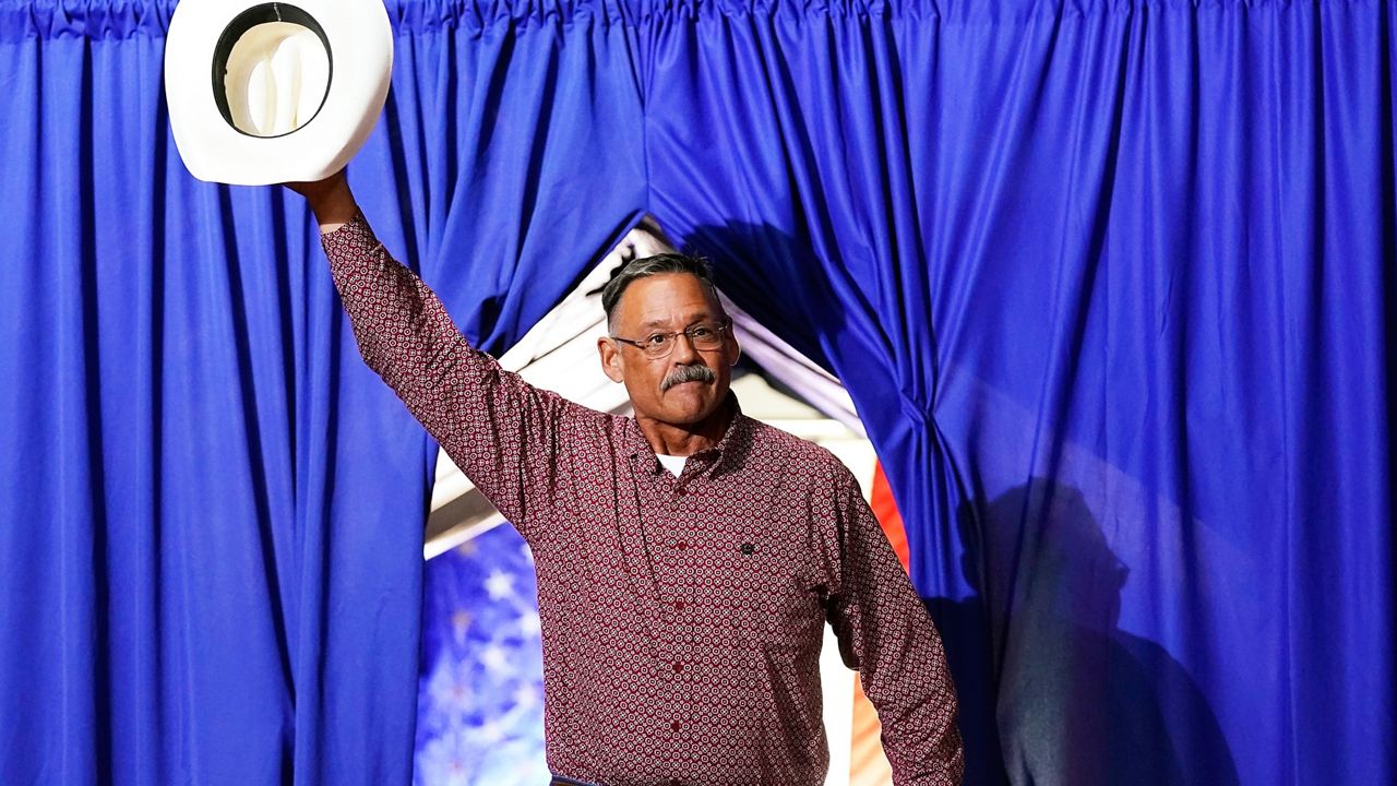 Mark Finchem, a Republican candidate for Arizona Secretary of State, waves to the crowd as he arrives to speak at a Save America rally Friday, July 22, 2022, in Prescott, Ariz. (AP Photo/Ross D. Franklin)