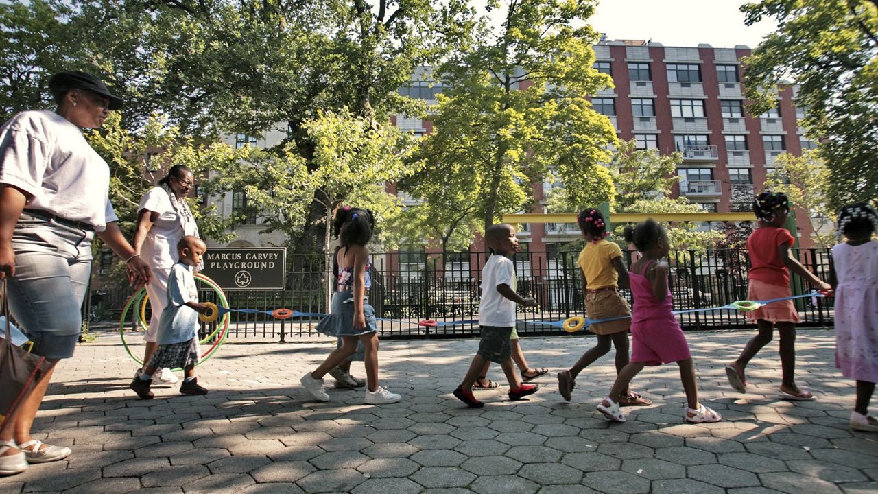 FILE - Children from a nearby daycare are escorted in Marcus Garvey Park in the Harlem neighborhood of New York Wednesday, Aug. 1, 2007. Some states have moved ahead with plans of their own to boost child care subsidies after a national effort by Democrats in Washington stalled. New York lawmakers passed a state budget in the spring that calls for it to spend $7 billion making child care more affordable over the next four years. (AP Photo/Bebeto Matthews, File)