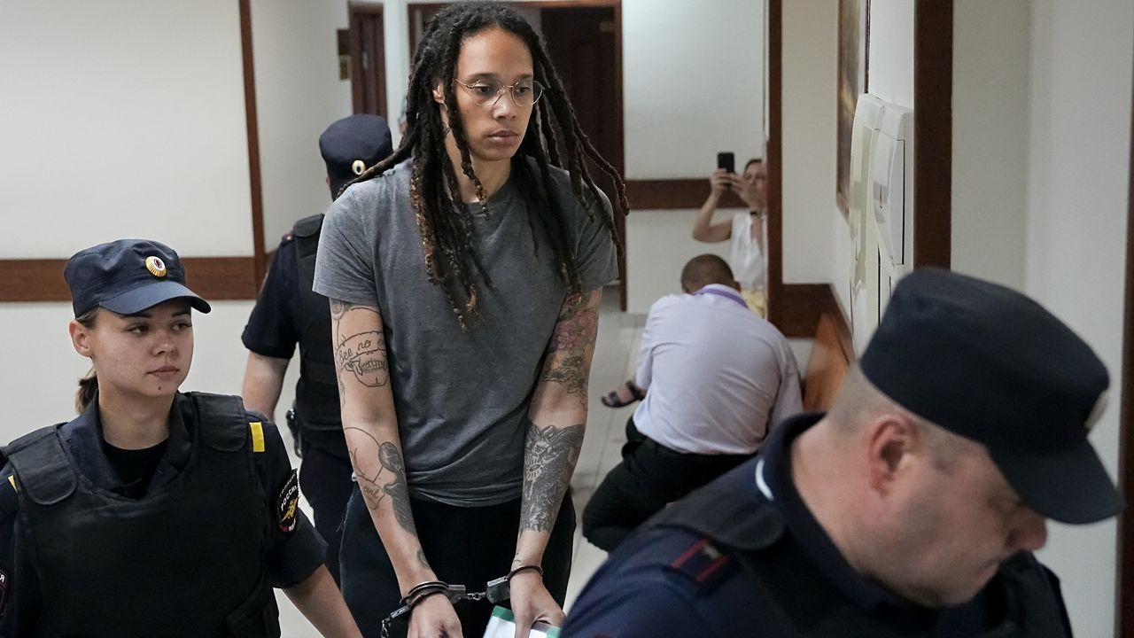 WNBA star and two-time Olympic gold medalist Brittney Griner is escorted from a court room ater a hearing, in Khimki just outside Moscow, Russia, Thursday, Aug. 4, 2022. A judge in Russia has convicted American basketball star Brittney Griner of drug possession and smuggling and sentenced her to nine years in prison. (AP Photo/Alexander Zemlianichenko)